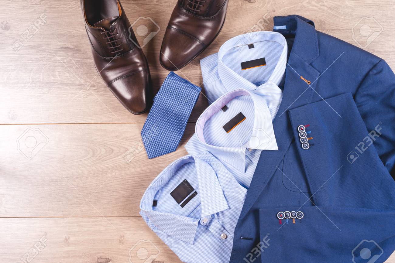 set of classic mens clothes , blue suit, shirts, brown shoes,..