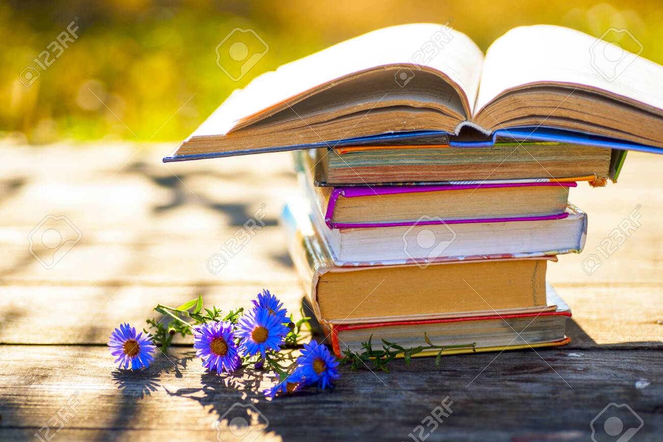 Open book on wooden table on natural background. Soft focus - 130717963 Open book on wooden table on natural background. Soft focus - 130717963