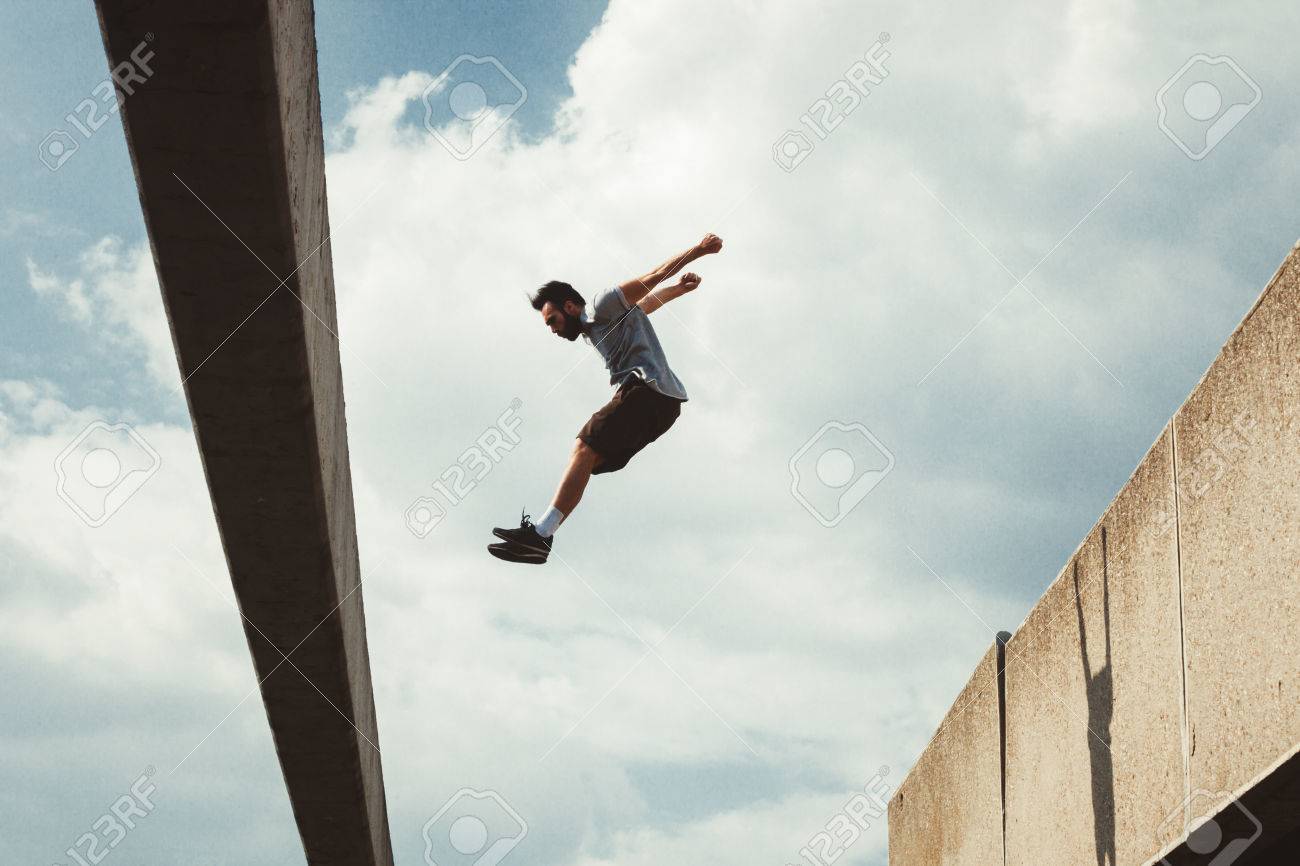 Young Man Doing Parkour Jump In Urban Space In The City Sunny Spring Summer  Day Stock Photo, Picture And Royalty Free Image. Image 76522174.