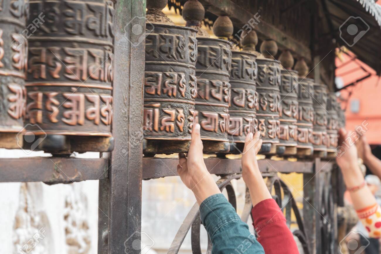 Tibetan prayer wheels at Swayambhunath, Nepal. Text translation: The magic symbol power of buddhism for prayer get divine blessings and good fortune. - 128411958 Tibetan prayer wheels at Swayambhunath, Nepal. Text translation: The magic symbol power of buddhism for prayer get divine blessings and good fortune. - 128411958