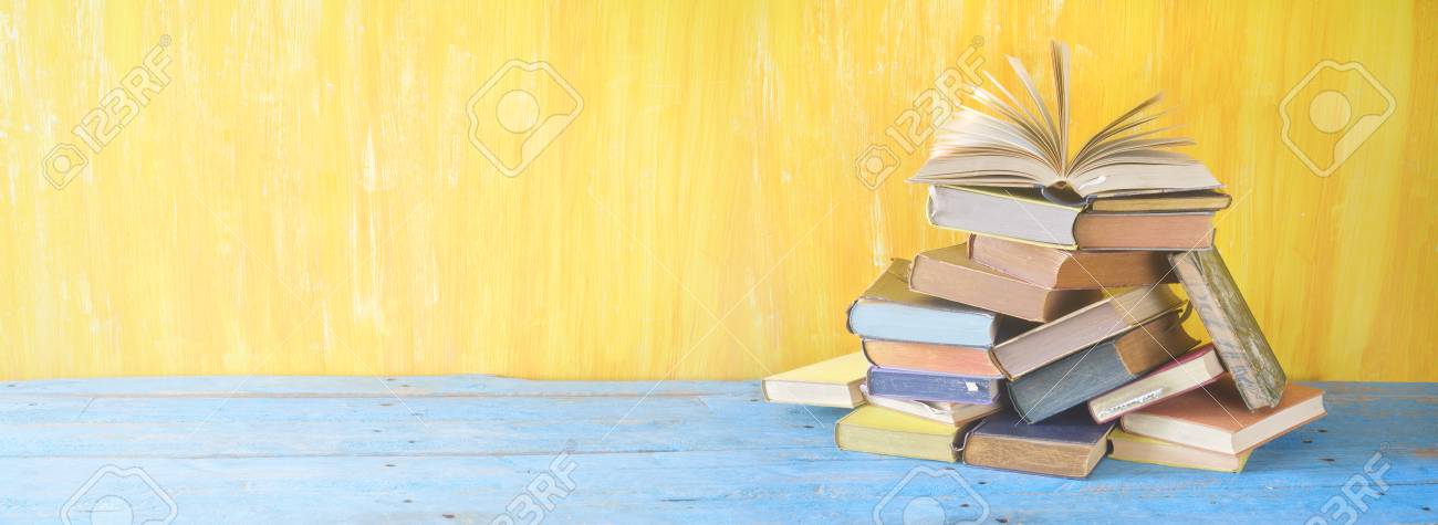 Opened book on a pile of books, panorama, good copy space - 96903508 Opened book on a pile of books, panorama, good copy space - 96903508