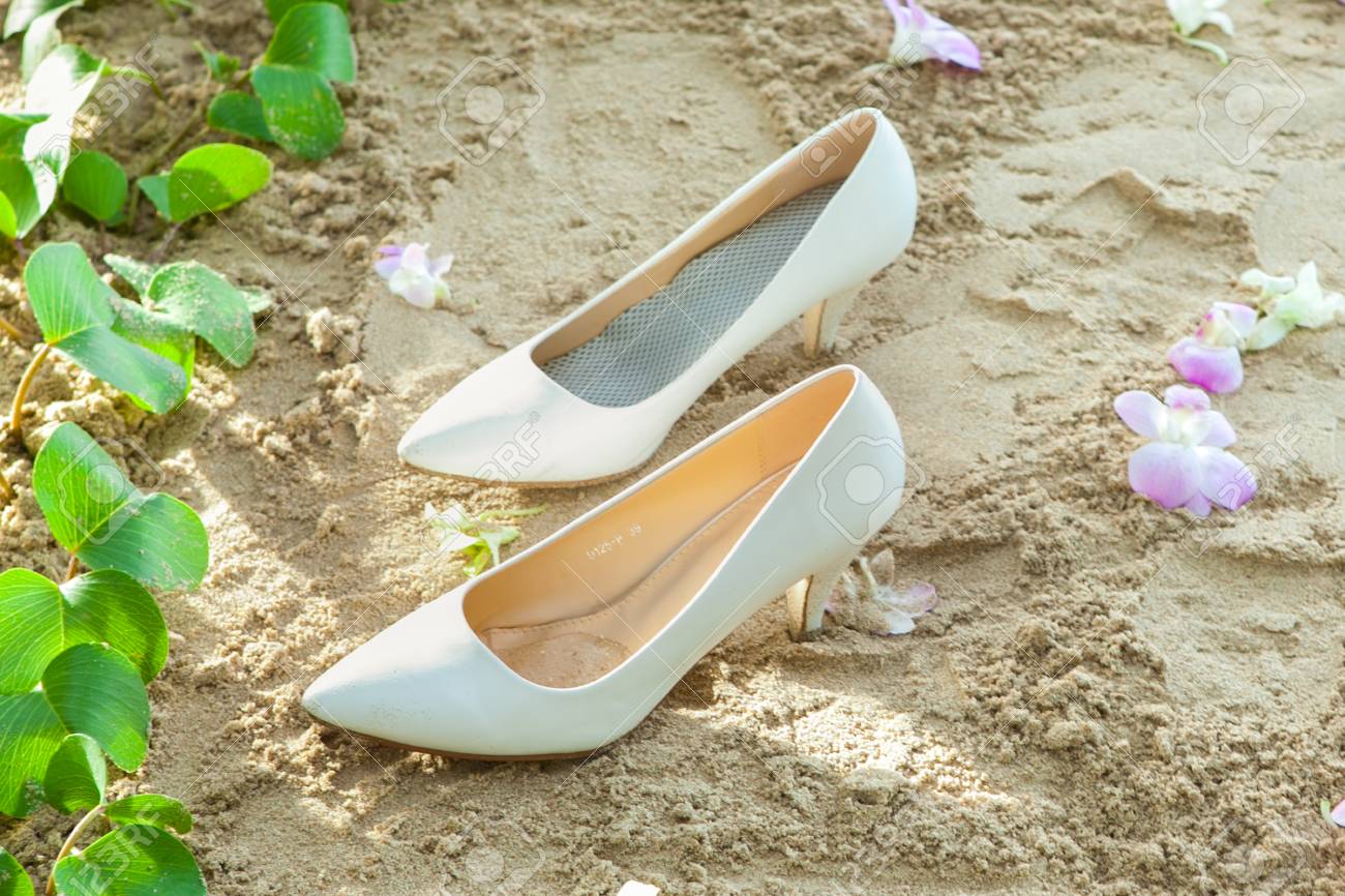 Bridal Shoes On Left Sands In A Beach Wedding Party