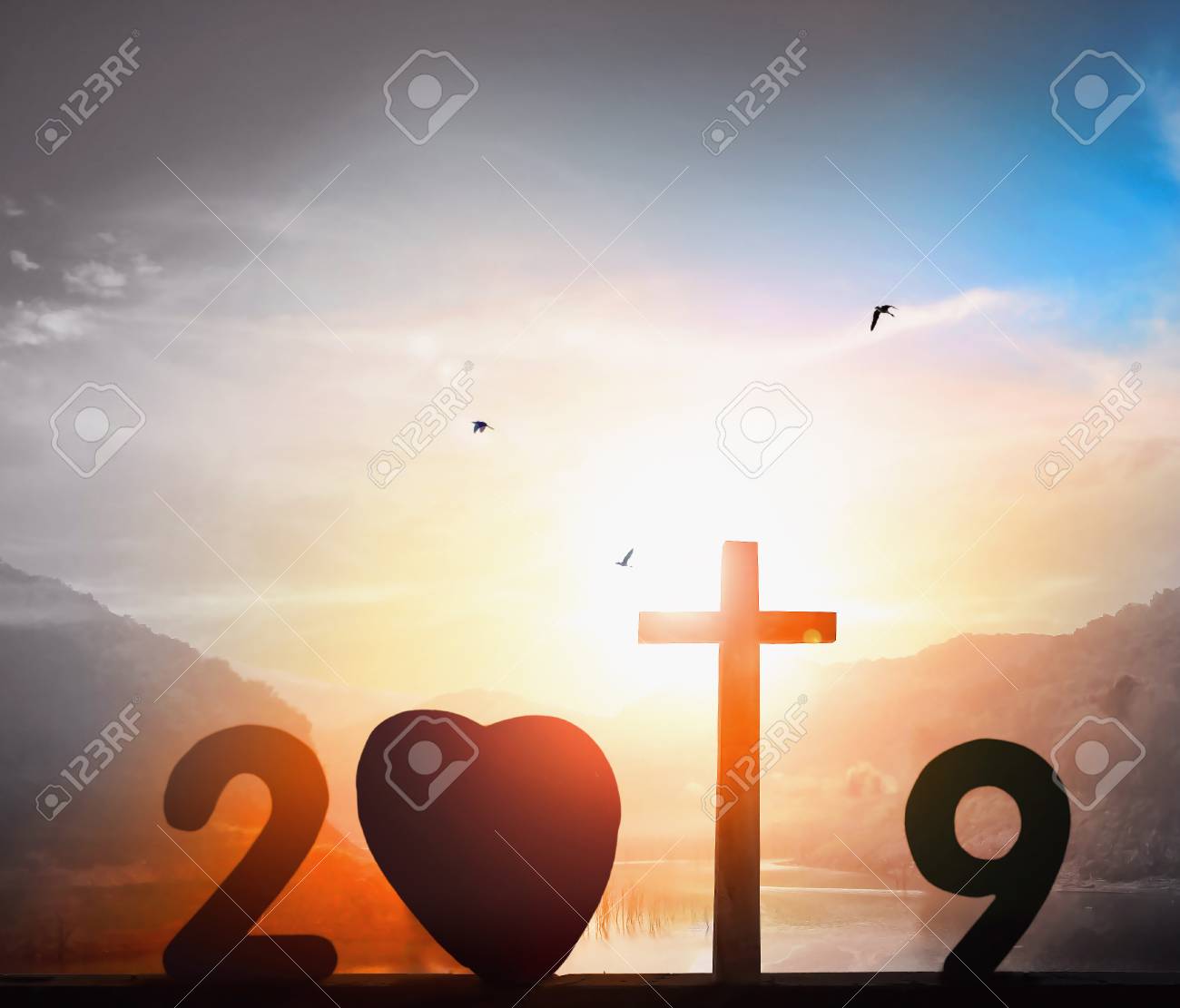 Christmas On Sunset 2019 2019 Christmas Concept: Cross Of Christ Jesus On Sunset Background Christmas On Sunset 2019 2019 Christmas Concept: Cross Of Christ Jesus On Sunset Background