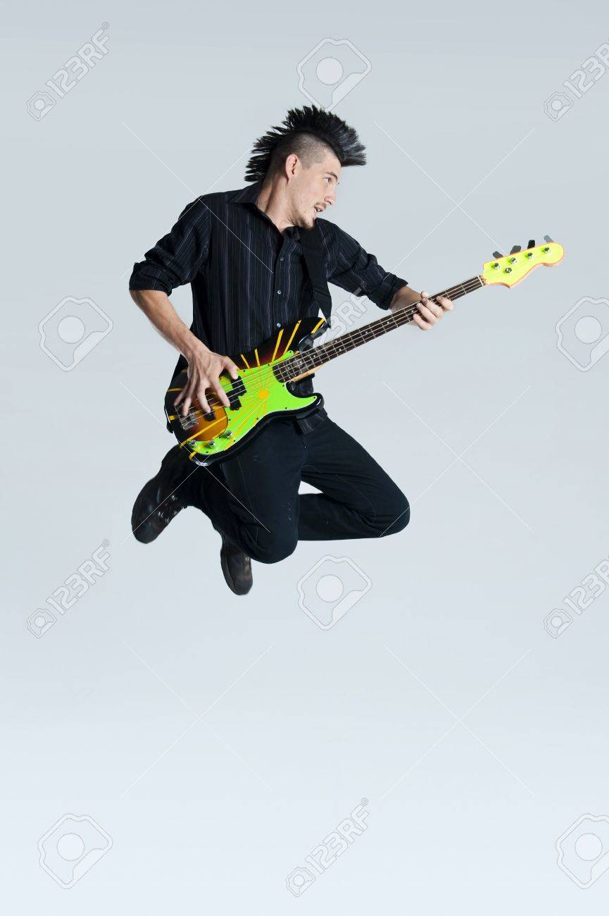 Awesome Mohawk Man Jumps With His Guitar In Studio Stock Photo Picture And Royalty Free Image Image