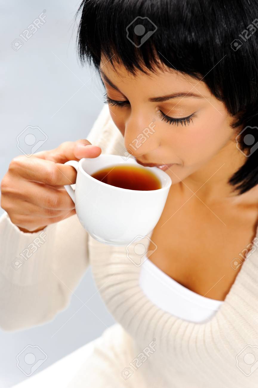Attractive Indian Woman Drinks A Hot Cup Of Tea To Warm Herself In Winter  Stock Photo, Picture and Royalty Free Image. Image 10861486.