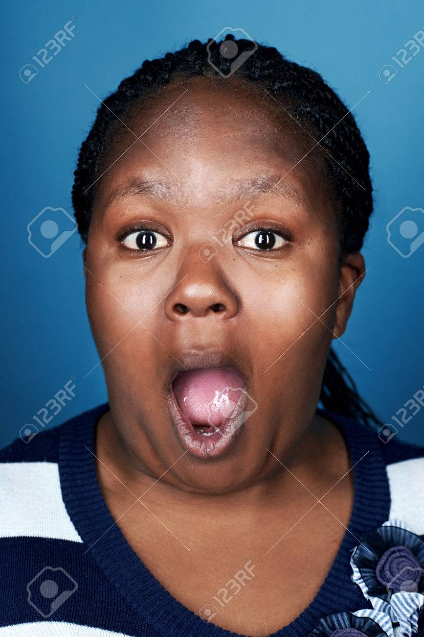 Portrait Of Real Funny Face African Woman On Blue Background Stock Photo,  Picture and Royalty Free Image. Image 22256147.