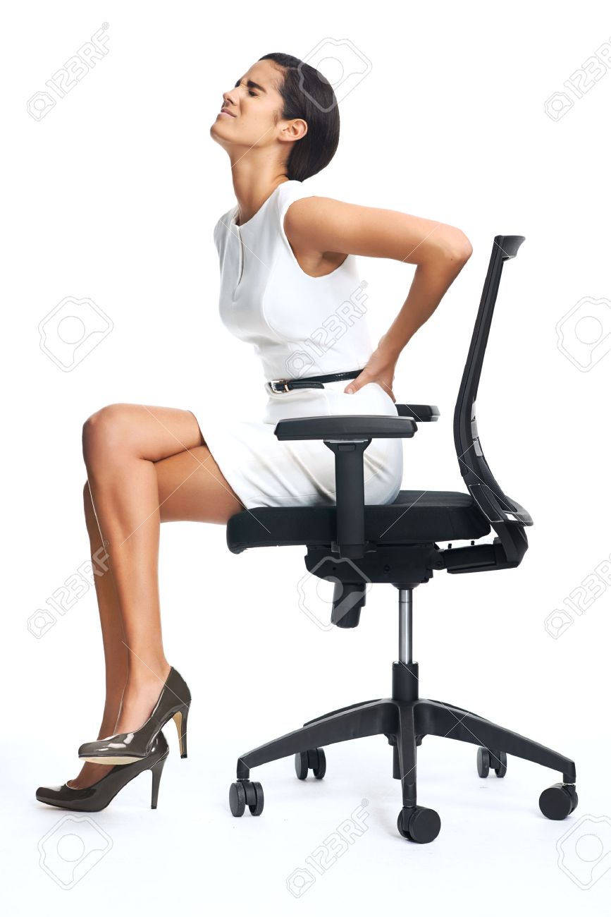 businesswoman with lower back pain from sitting on office chair businesswoman with lower back pain from sitting on office chair