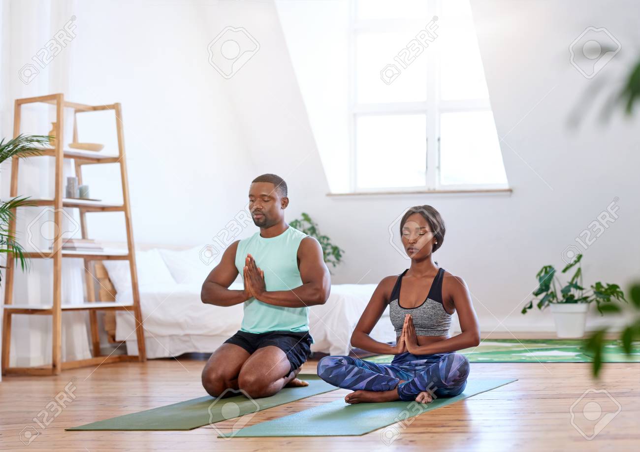 Calm relaxed couple meditating at home doing yoga relaxation - 83861819 Calm relaxed couple meditating at home doing yoga relaxation - 83861819