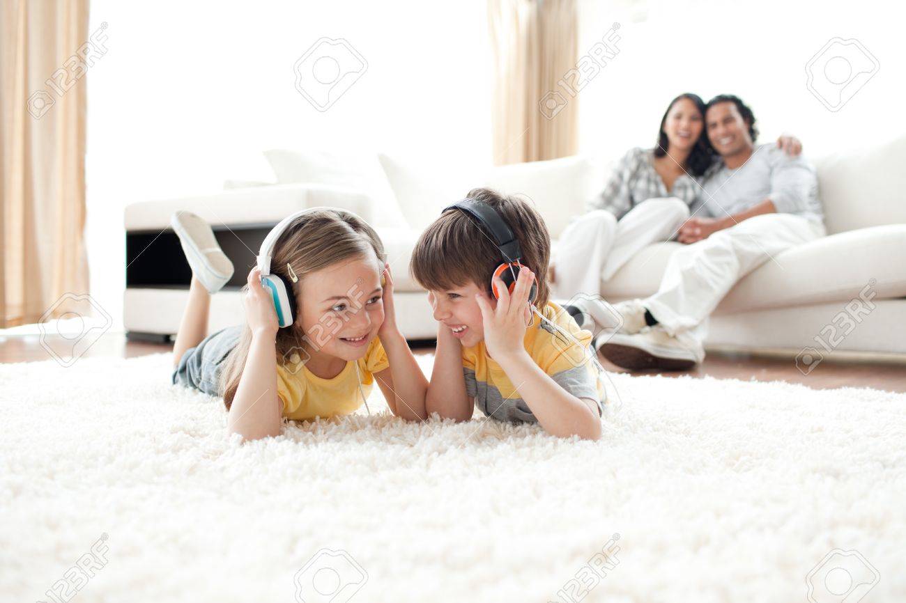 Brother and sister listening music with headphones - 10096321 Brother and sister listening music with headphones - 10096321
