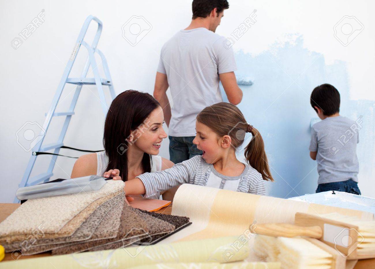 People Decorating Home smiling family decorating their new home stock photo, picture and People Decorating Home smiling family decorating their new home stock photo, picture and