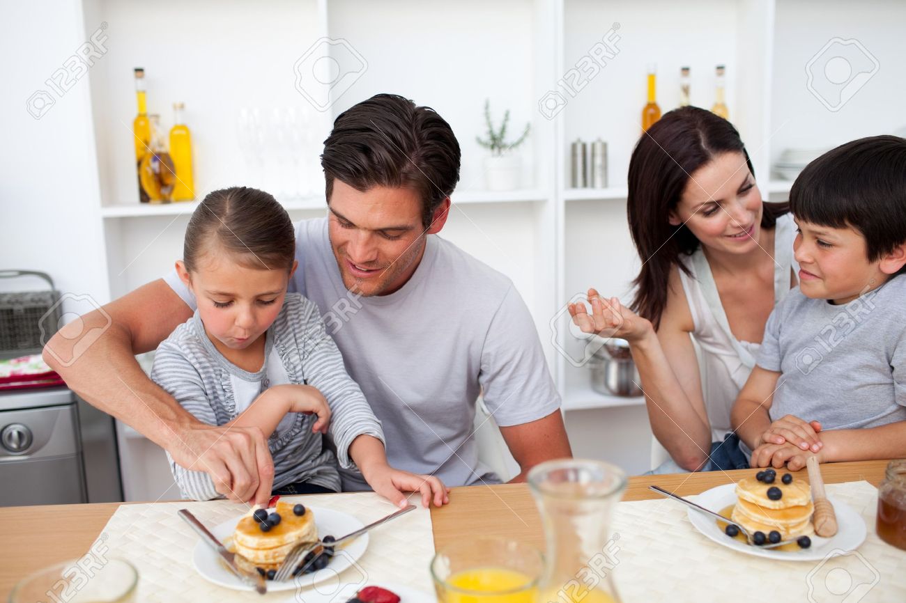 Young family having breakfast together - 10112365 Young family having breakfast together - 10112365
