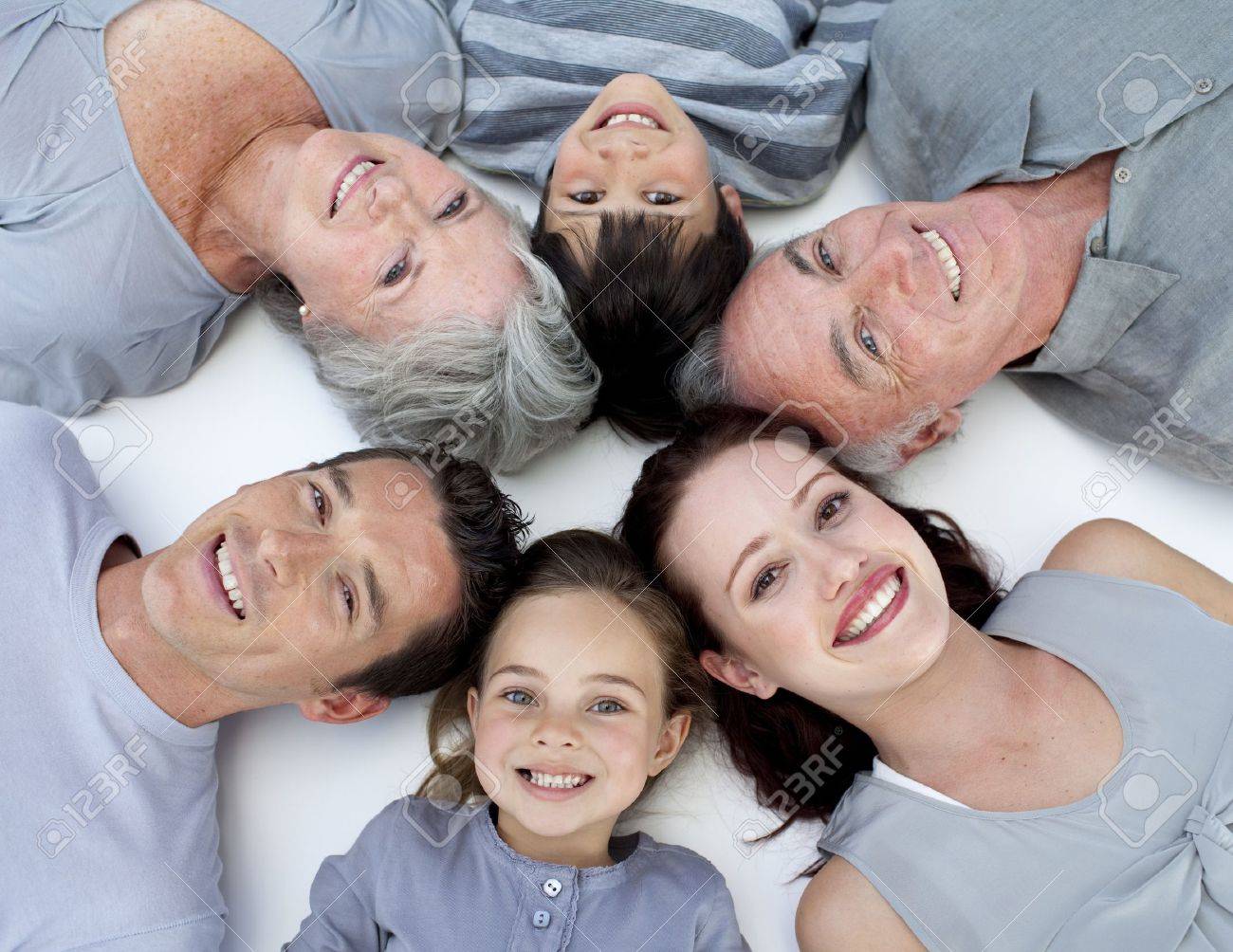 High angle of family lying on floor with heads together - 10248838 High angle of family lying on floor with heads together - 10248838