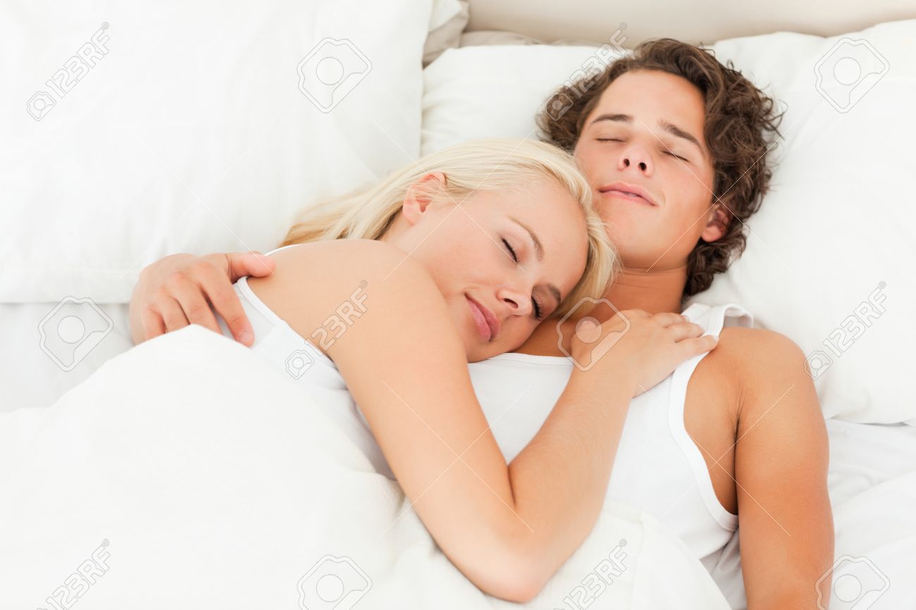 Lovely Couple Sleeping In Their Bedroom
