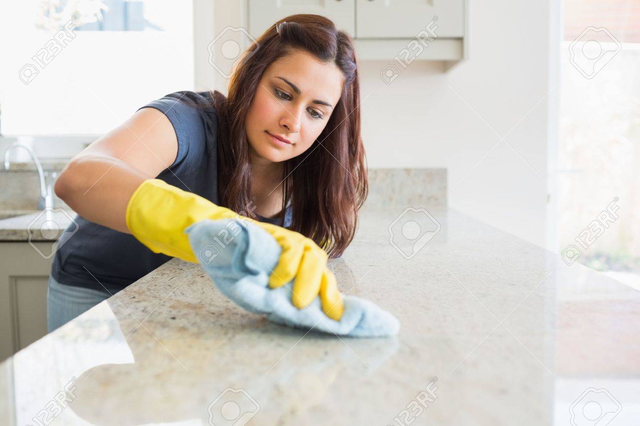 Concentrated woman scrubbing the bar in kitchen - 15589920 Concentrated woman scrubbing the bar in kitchen - 15589920