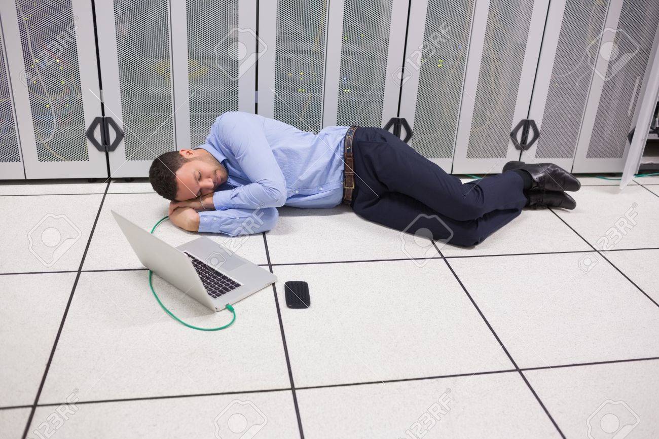 Man Sleeping In Data Center On The Floor Stock Photo Picture And