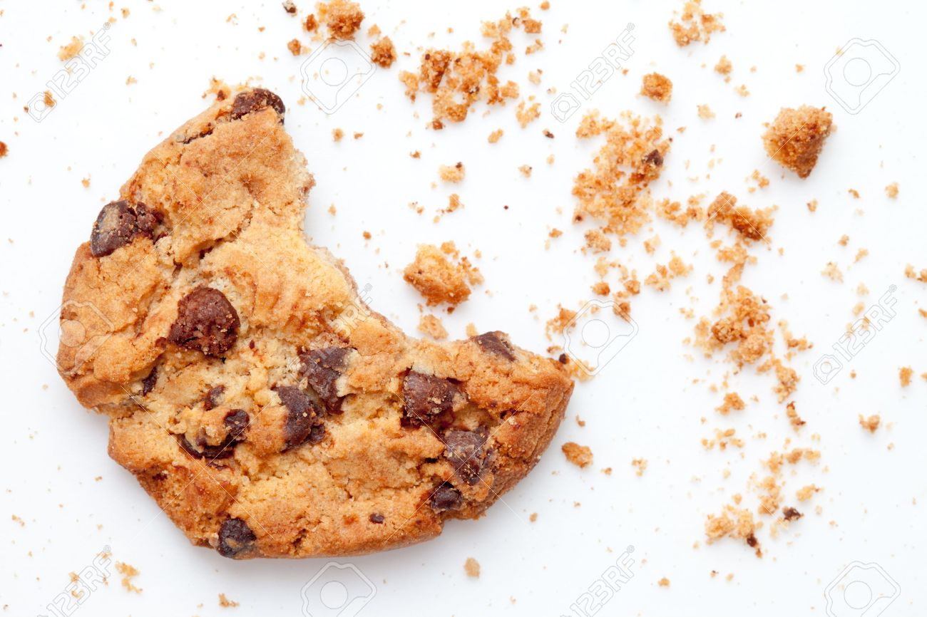 Close up of an half eaten cookie with crumb against a white background - 16206781 Close up of an half eaten cookie with crumb against a white background - 16206781