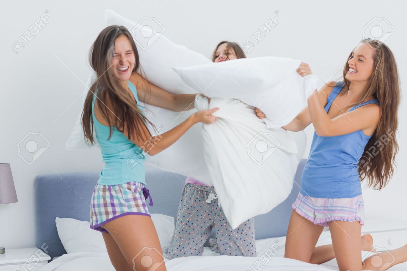Friends Having Pillow Fight At Home At Slumber Party Stock Photo, Picture  and Royalty Free Image. Image 25819257., image size:1300x866