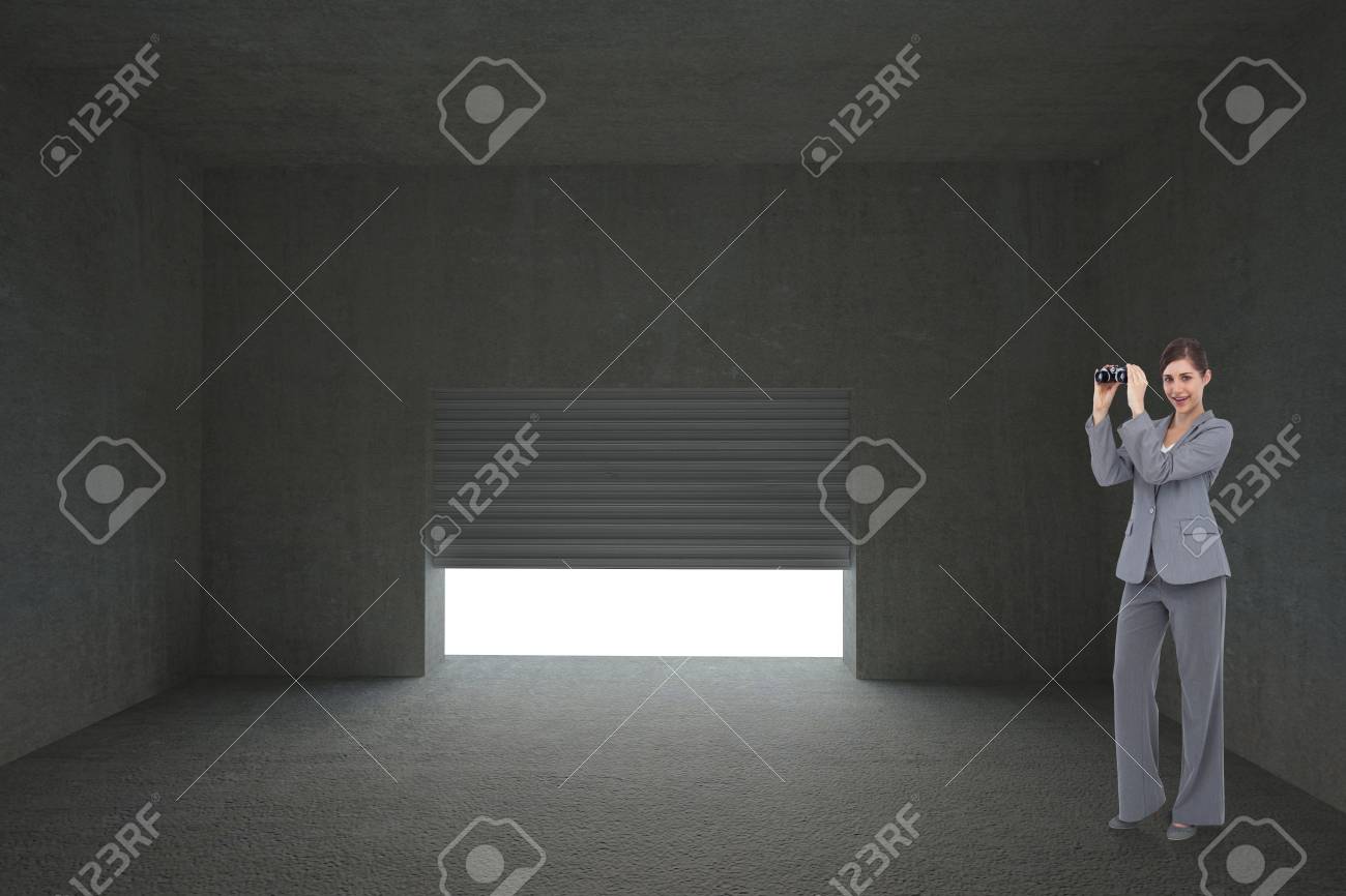 シャッターの暗い部屋で開口部に対して双眼鏡でポーズ実業家 の写真素材 画像素材 Image 26850430