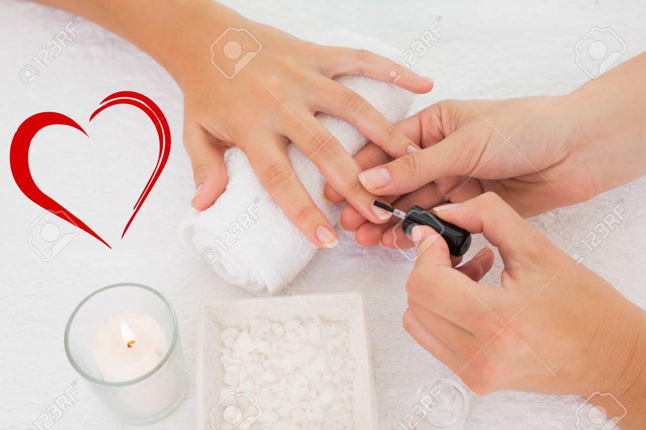 nail technician painting customers nails against heart stock photo nails technician