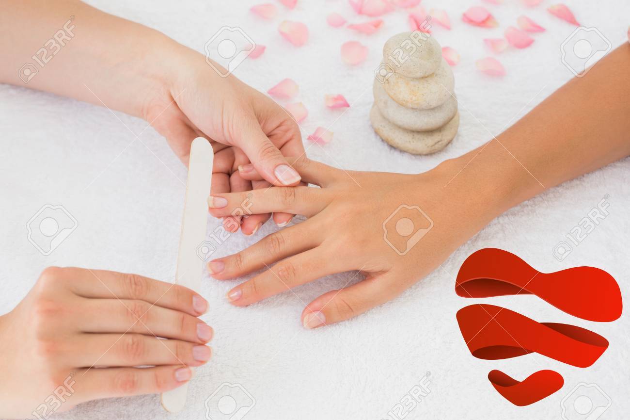 nail technician filing customers nails against heart stock photo nails technician