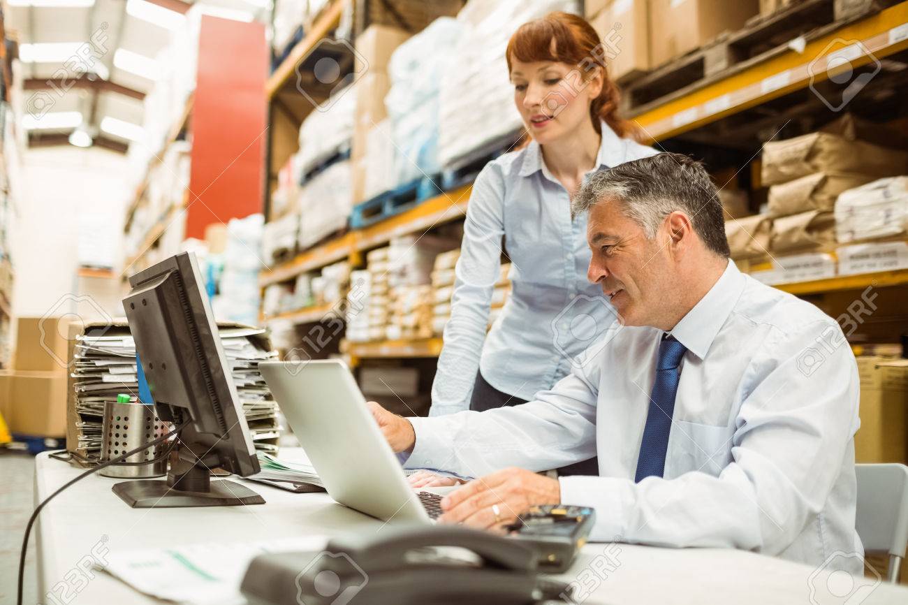 大規模な倉庫でノート パソコンで一緒に作業倉庫管理者 の写真素材 画像素材 Image