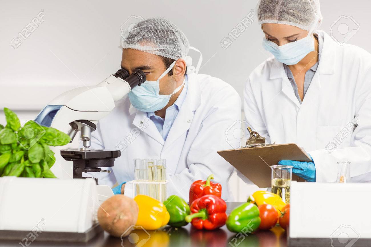 food scientists using the microscope for research at the university food scientist