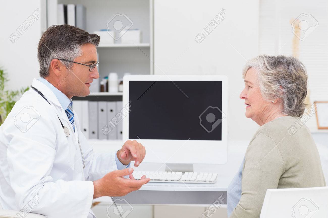 Side View Of Male Doctor Conversing With Senior Patient At Table Stock Photo Picture And Royalty Free Image Image 36414397