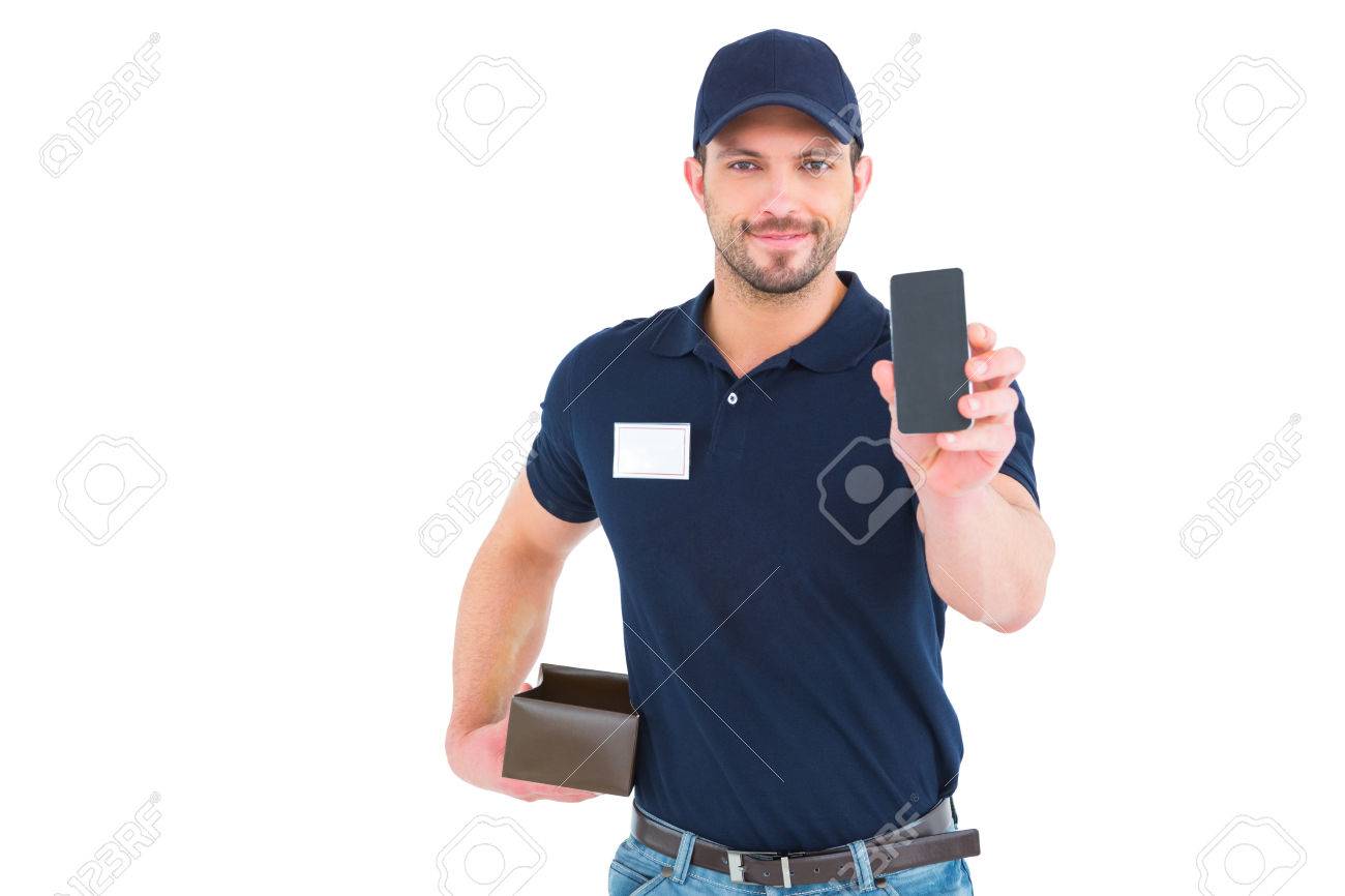 handsome delivery man showing mobile phone on white background stock