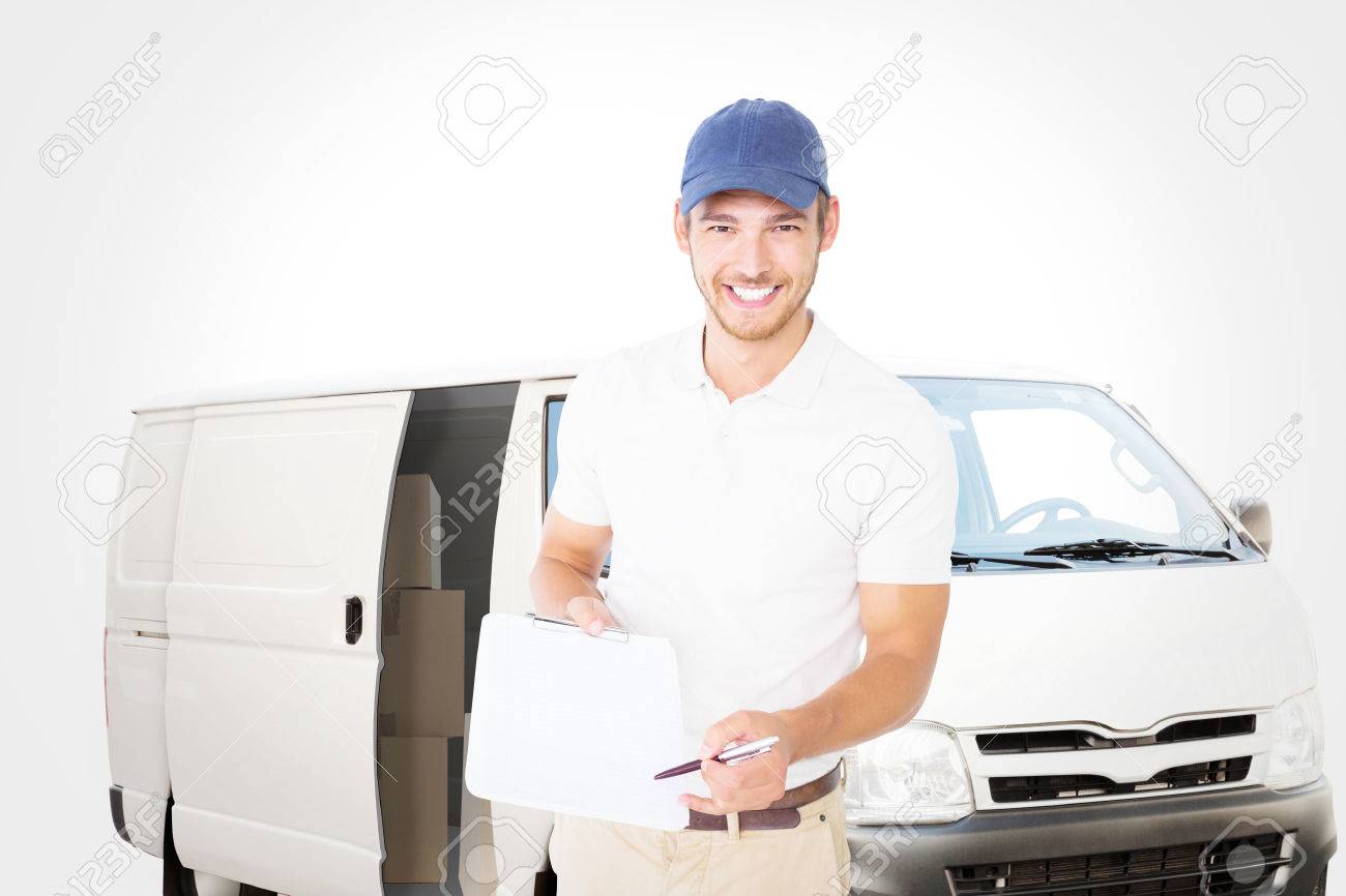 happy delivery man holding clipboard against white delivery van