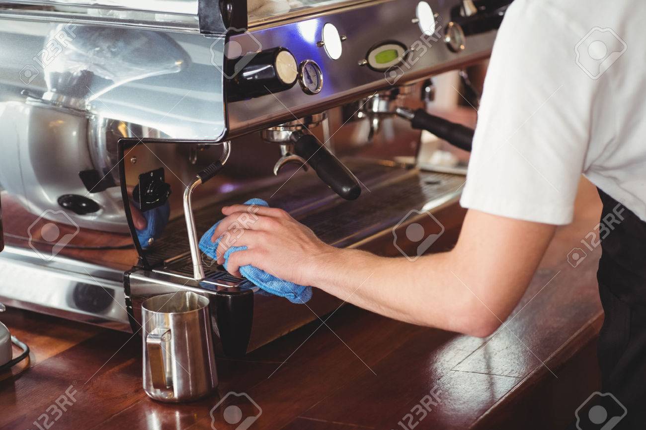 Barista Cleaning Coffee Machine At 