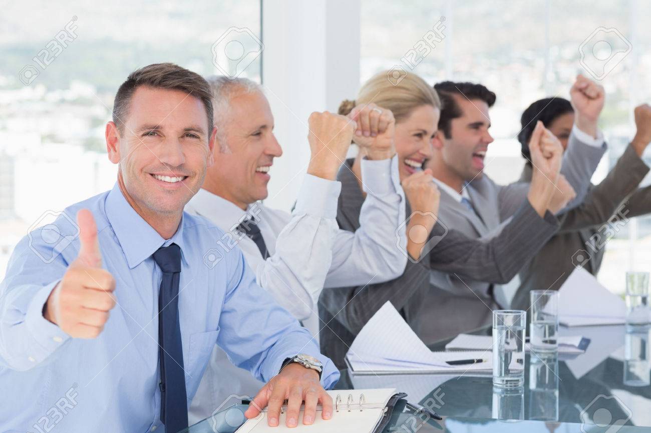 image: 42519073-Business-team-celebrating-a-good-job-in-the-office-Stock-Photo