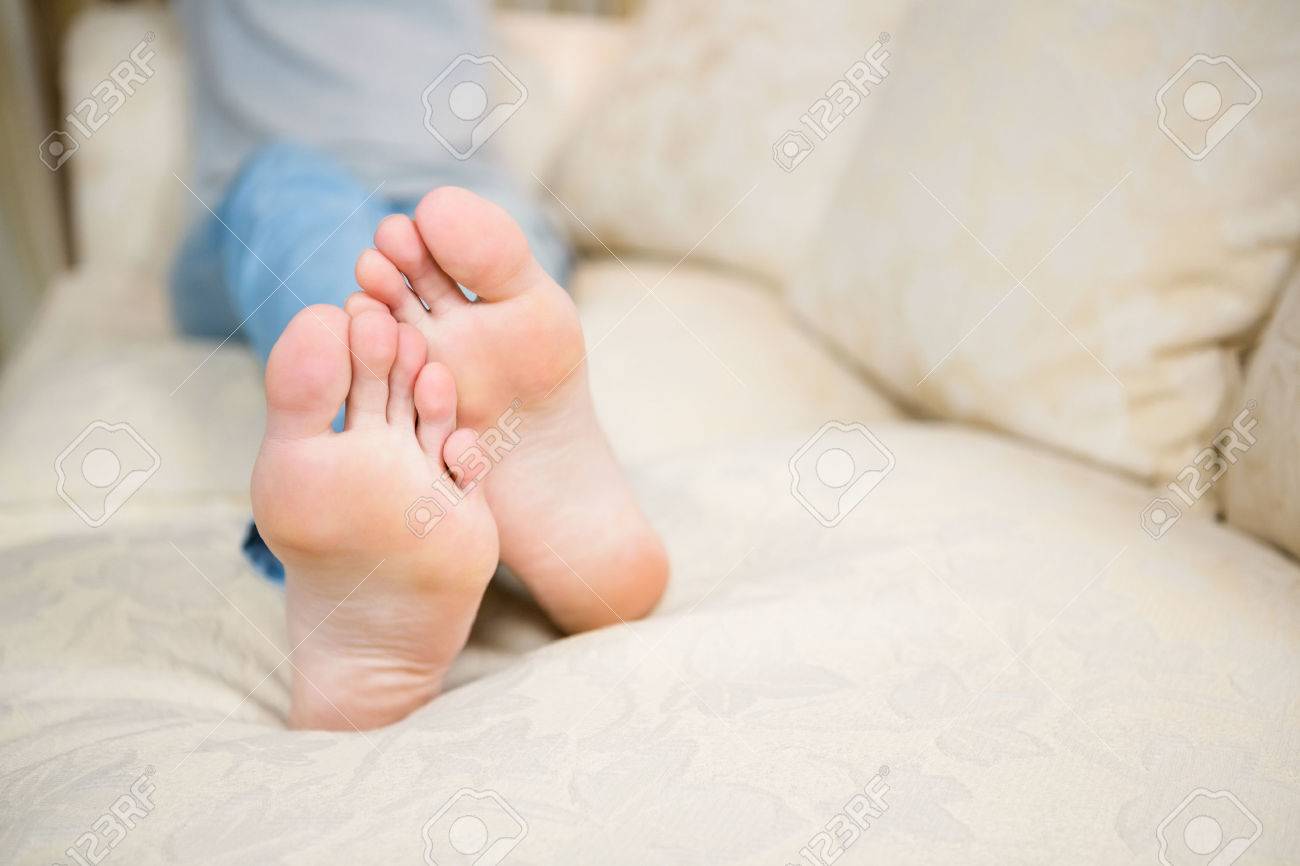 Feet Of Woman On The Sofa At Home Stock Photo, Picture and Royalty Free  Image. Image 51384015., image size:1300x866