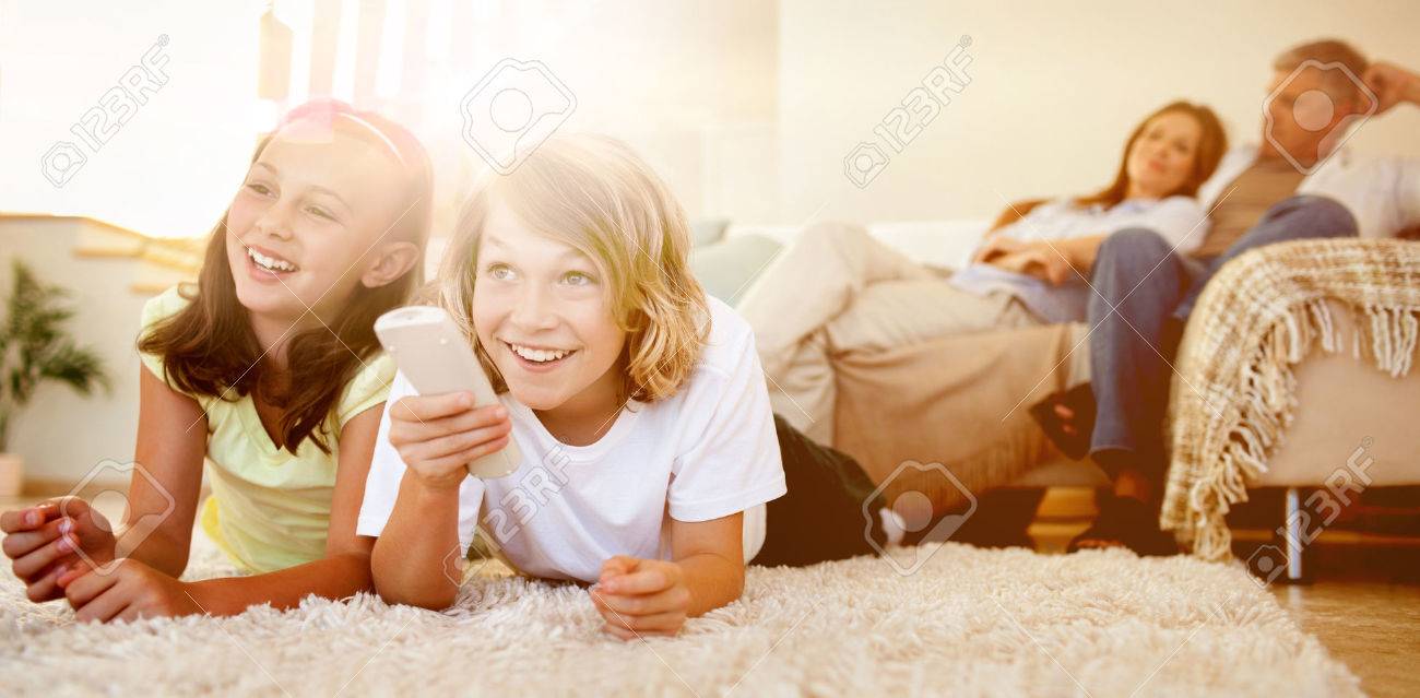 Siblings lying on the floor watching tv together - 56319210 Siblings lying on the floor watching tv together - 56319210