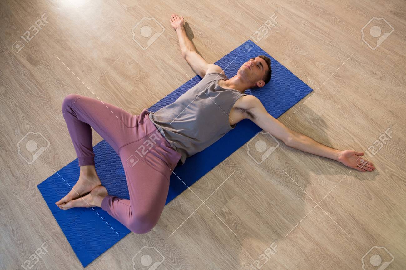 man in yoga corpse pose in gym stock photo picture and royalty free