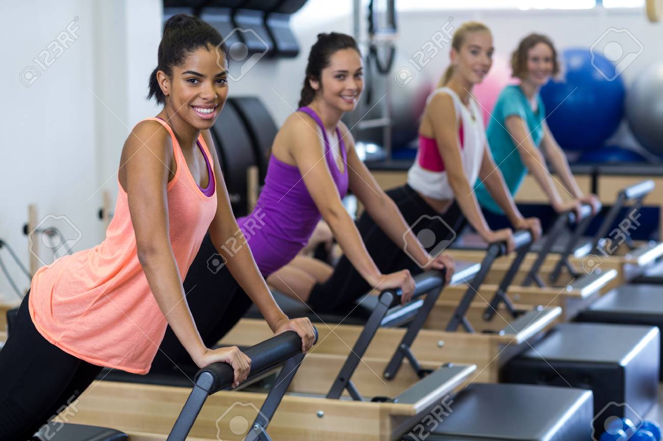 Group of women exercising on reformer in gym - 75139863 Group of women exercising on reformer in gym - 75139863