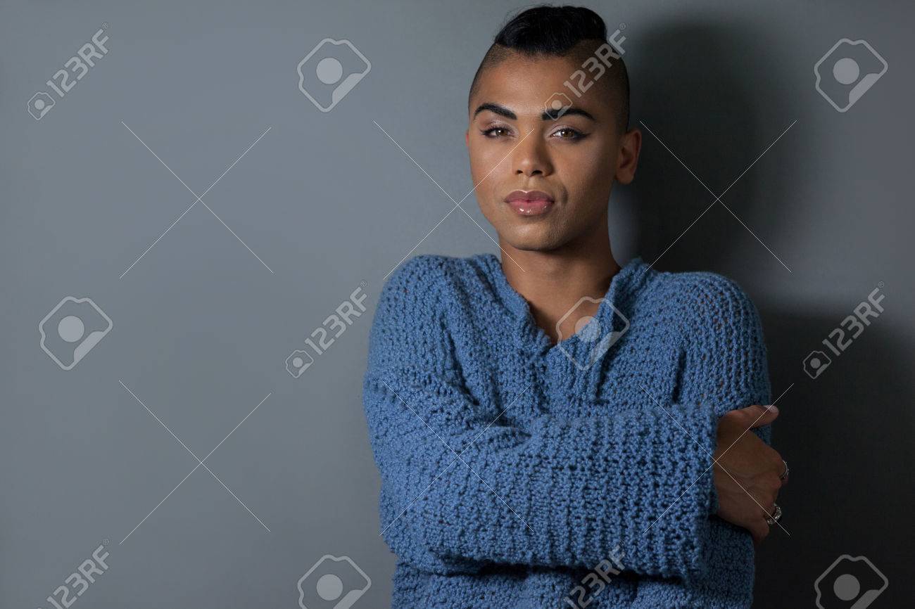 Portrait of confident embracing against gray background - 76068827 Portrait of confident embracing against gray background - 76068827