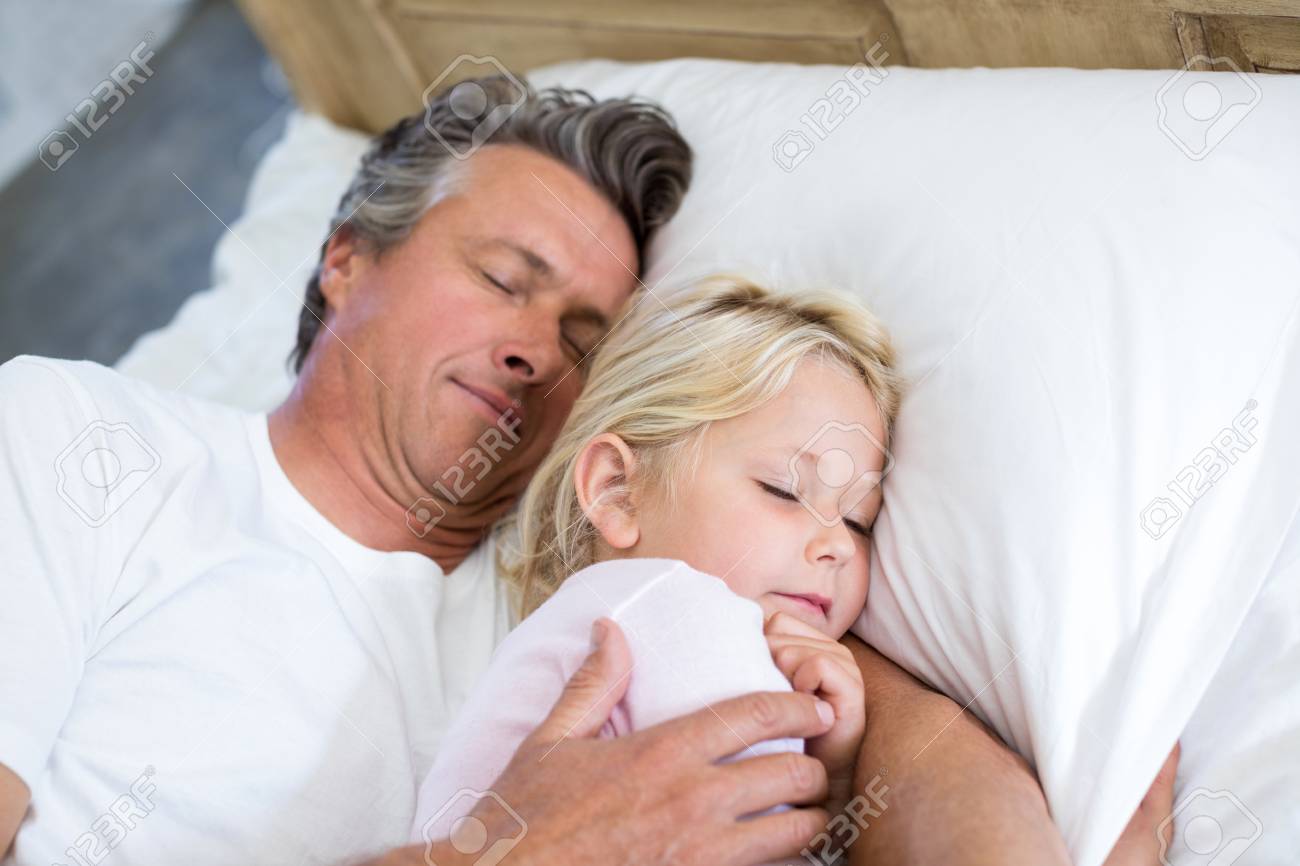 Father And Daughter Sleeping Together On Bed In Bedroom At Home Stock  Photo, Picture and Royalty Free Image. Image 81572505.