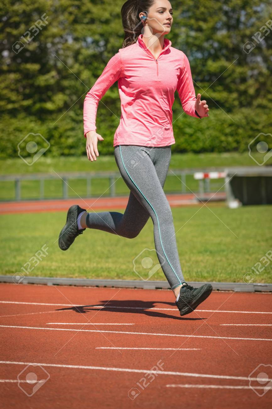 young woman jogging on a race track stock photo picture and royalty