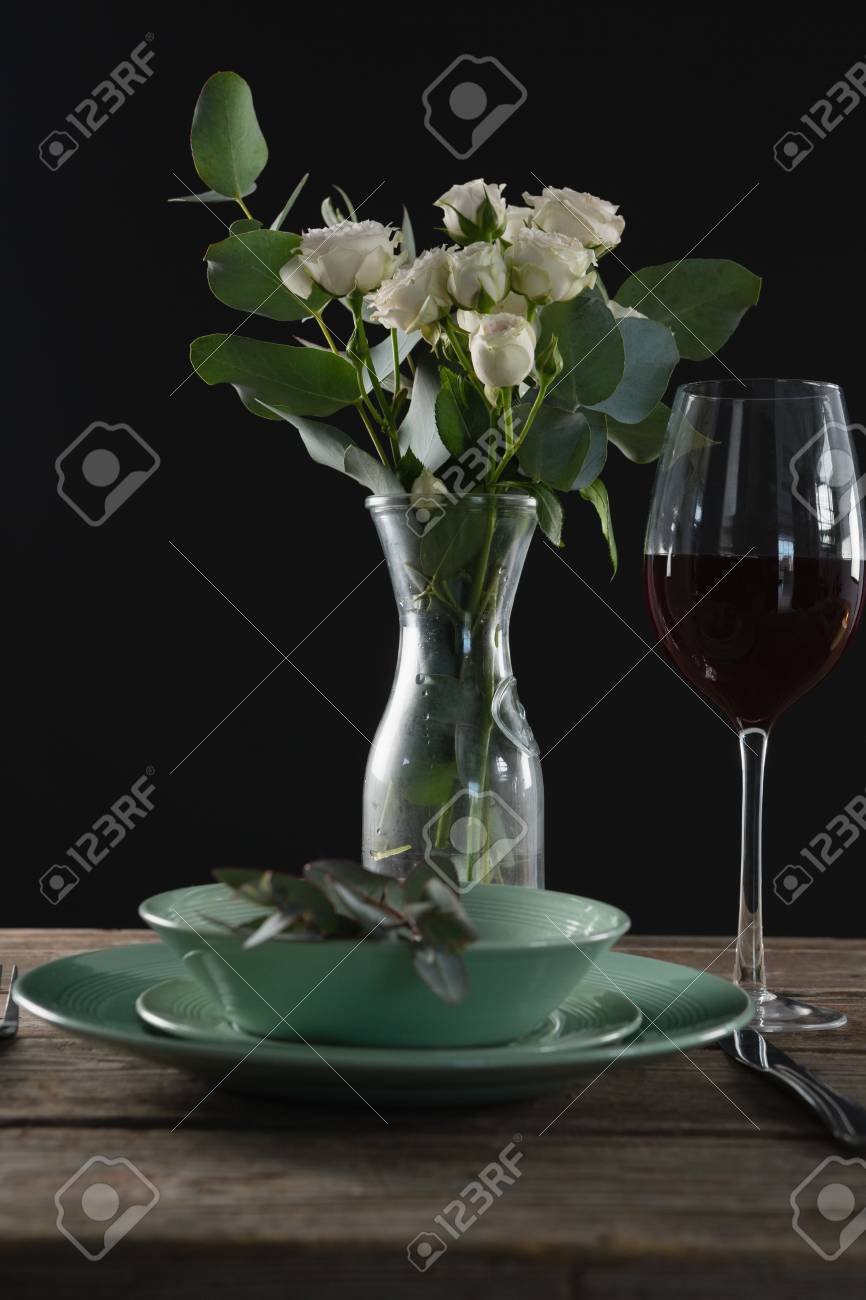 Setting A Table For A Dinner Party With Wine Glass And Flower