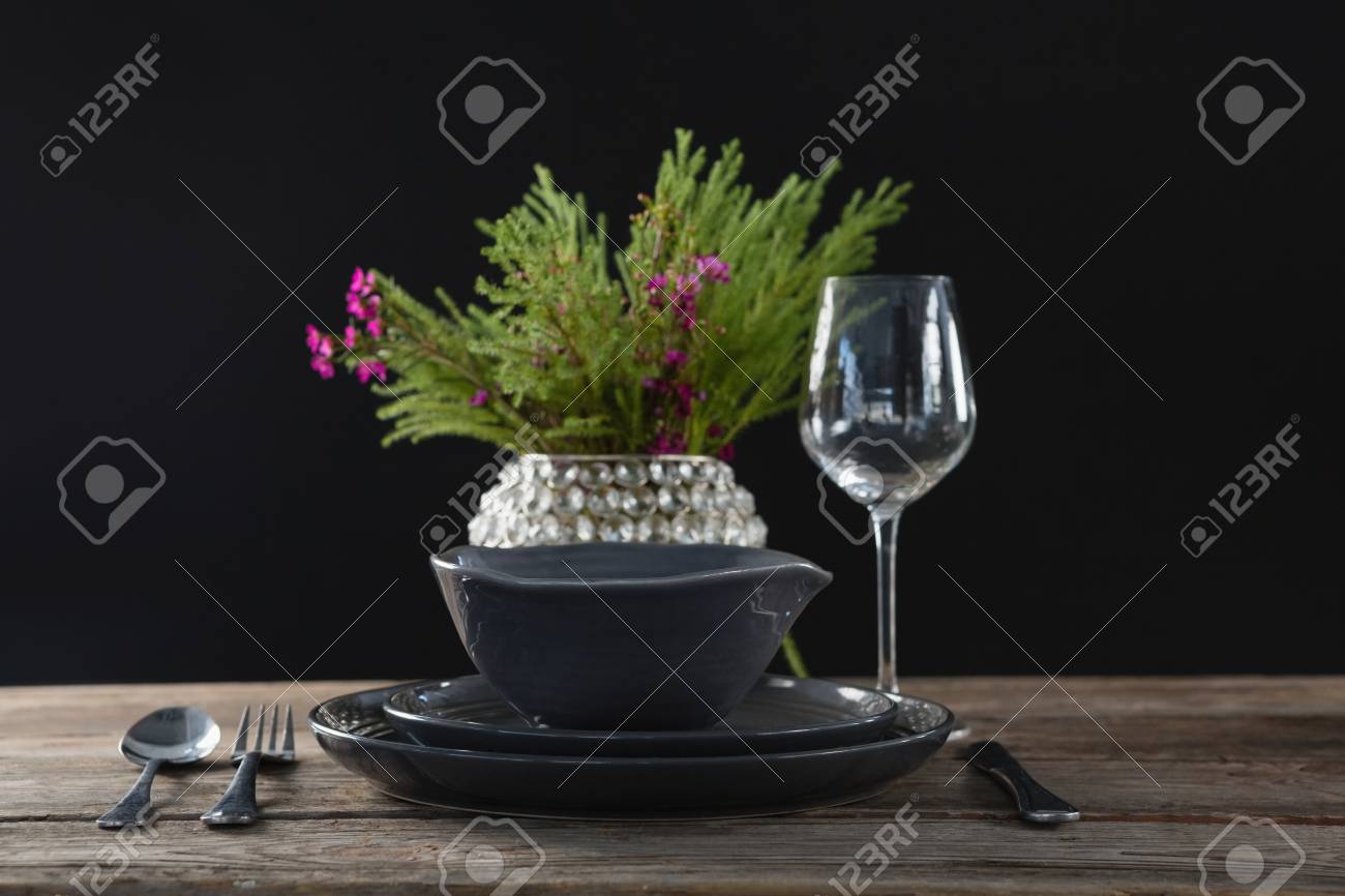 Setting A Table For A Dinner Party With Wine Glass And Flower