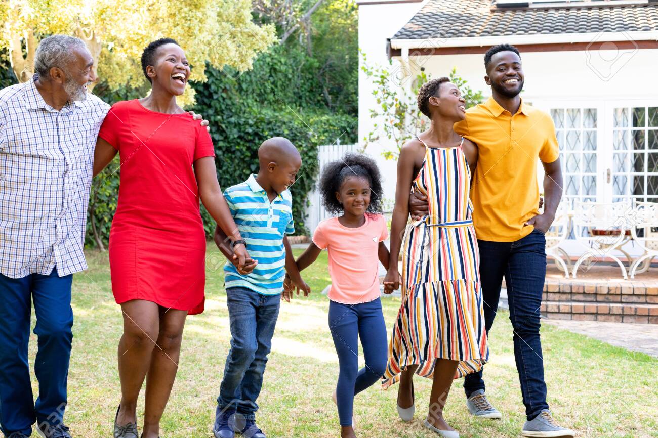 Three Generation African American Family Spending Time In Their Garden On A  Sunny Day, Walking On A Lawn, Holding Hands And Smiling. Stock Photo,  Picture and Royalty Free Image. Image 147209757., image size:1300x866