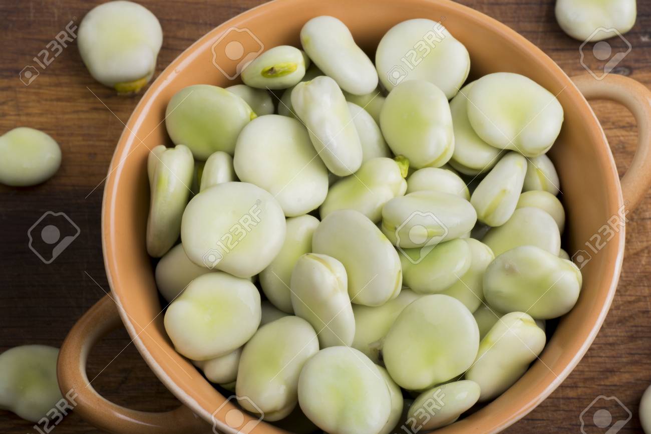 Fresh broad beans in bowl on wooden board - 60747629 Fresh broad beans in bowl on wooden board - 60747629