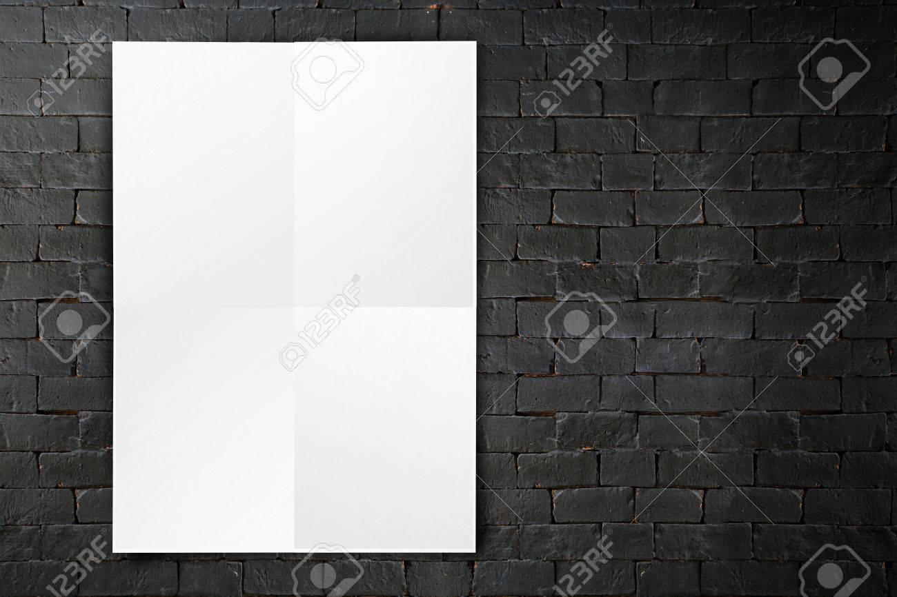 blank folded paper poster hanging on black brick wall template