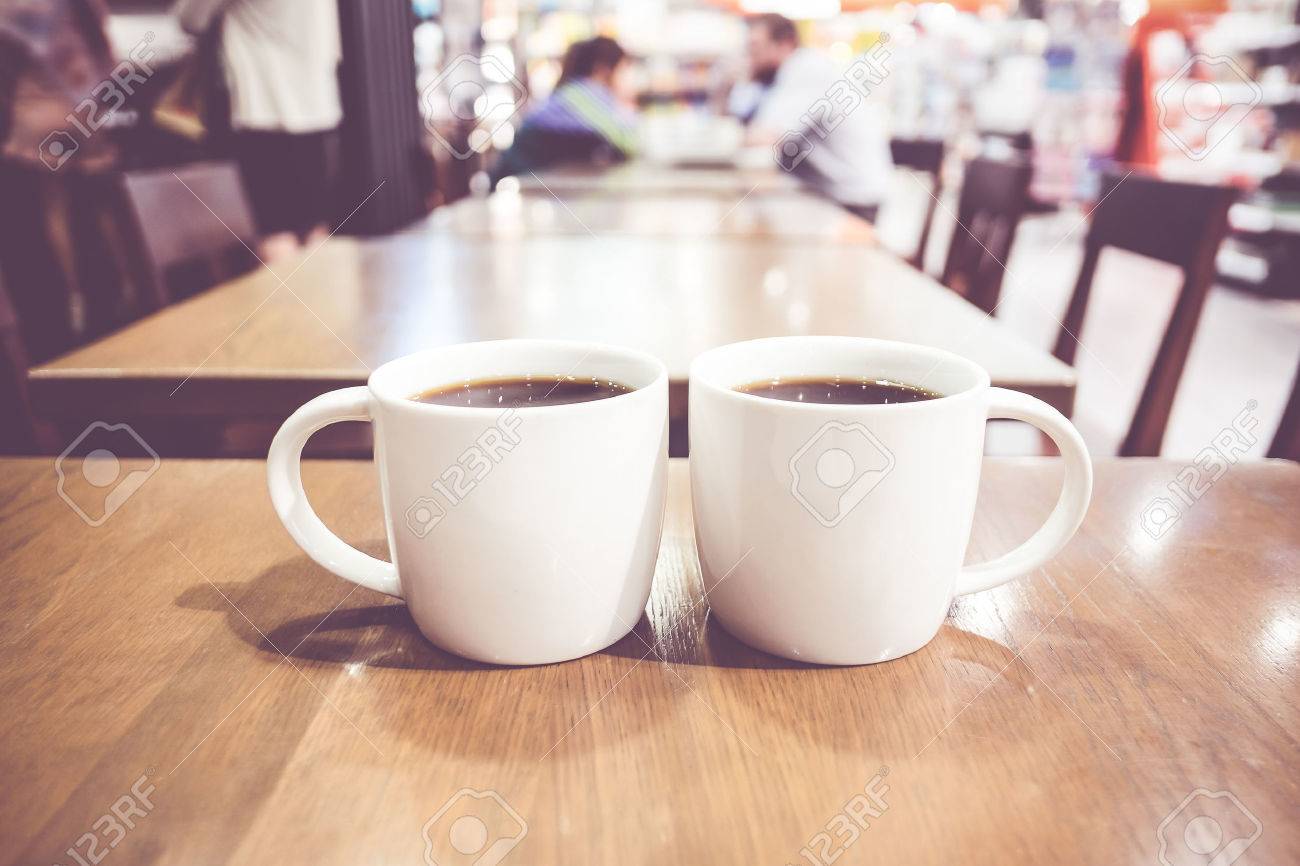 vintage filter couple of white coffee cup on wood table with