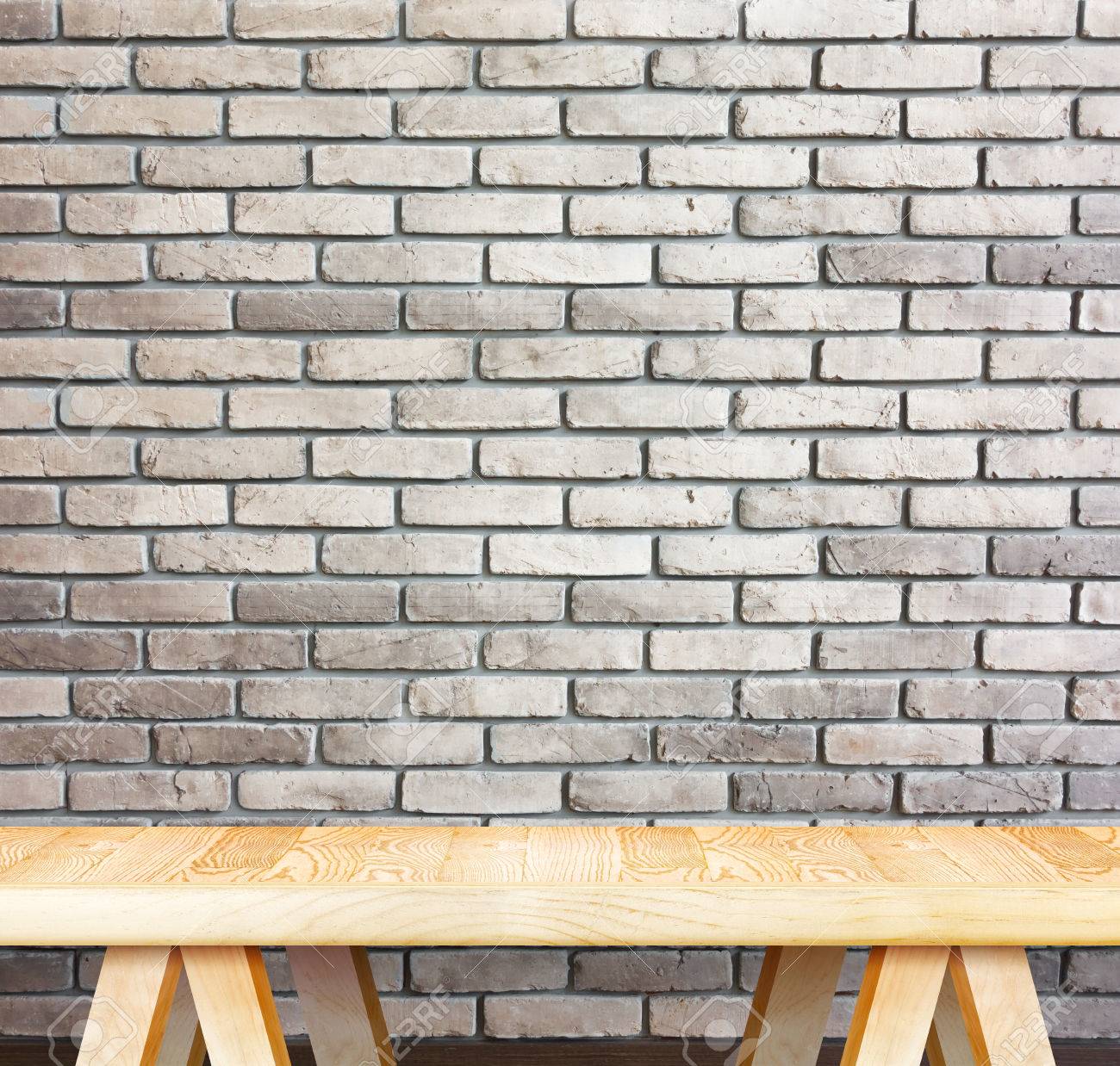 blank modern wooden table with leg at red brick wall template