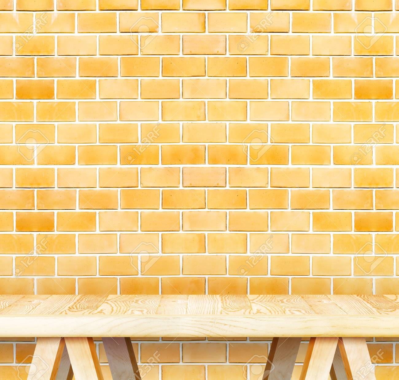 blank modern wooden table with leg at orange brick wall template