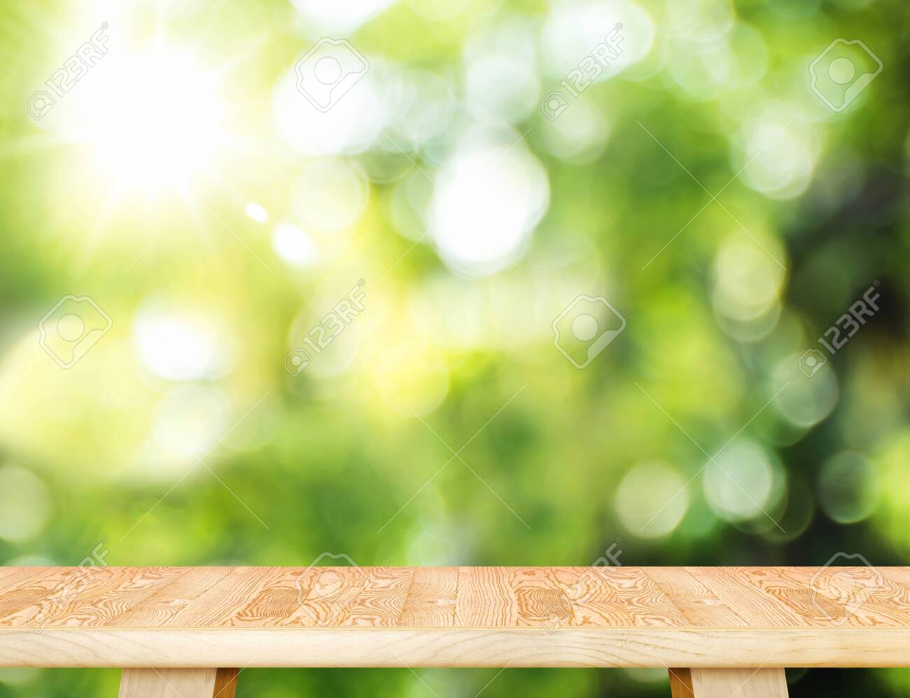 Empty wood plank table top with blur tree in park with bokeh light at background,Mock up template for display of your design,Banner for advertise of product - 143566131 Empty wood plank table top with blur tree in park with bokeh light at background,Mock up template for display of your design,Banner for advertise of product - 143566131