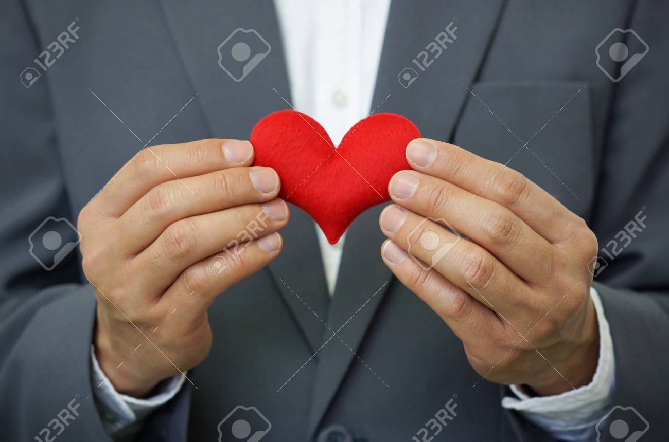 businessman holding a red heart crm service mind stock photo crmservice