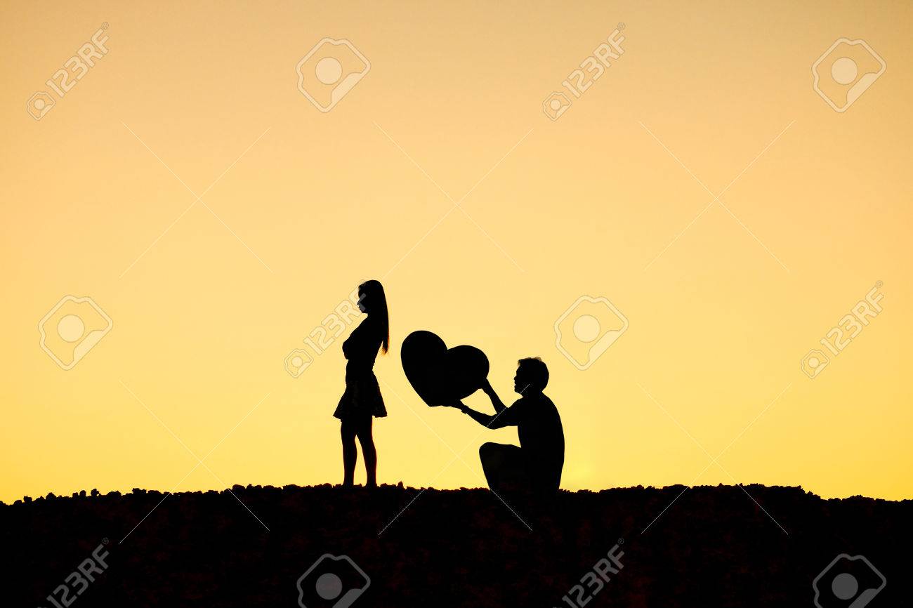 A Man Holding A Big Heart And An Angry Woman Difficult Love