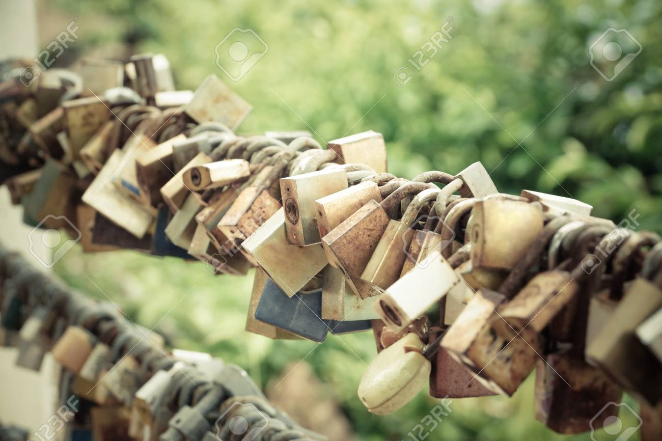 old locks hung on metal wire representing long lasting love of